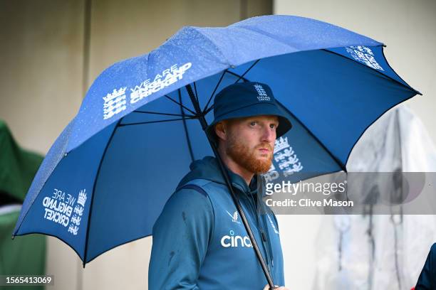 Ben Stokes of England looks on during the end of match presentations as he shelters from the rain on day five of the LV=Insurance Ashes 4th Test...