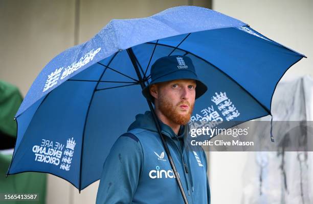 Ben Stokes of England looks on during the end of match presentations as he shelters from the rain on day five of the LV=Insurance Ashes 4th Test...