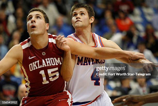Oklahoma Sooners forward Tyler Neal and Texas-Arlington Mavericks guard Drew Charles battle for position in the first half at the College Park Center...