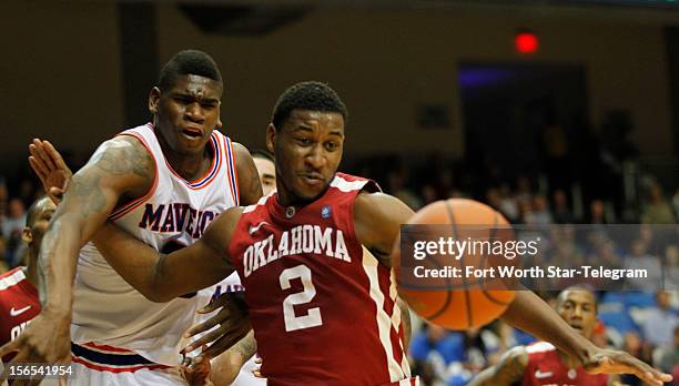 Texas-Arlington Mavericks forward Brandon Edwards, left, gets pushed away from by Oklahoma Sooners guard Steven Pledger during game action at the...