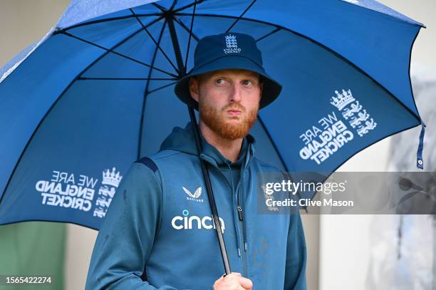 Ben Stokes of England looks on during the end of match presentations as he shelters from the rain on day five of the LV=Insurance Ashes 4th Test...