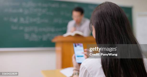 student use mobile in class - korean highschool student stock pictures, royalty-free photos & images