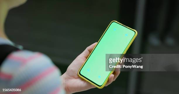 woman use phone at station - metro screen door stockfoto's en -beelden