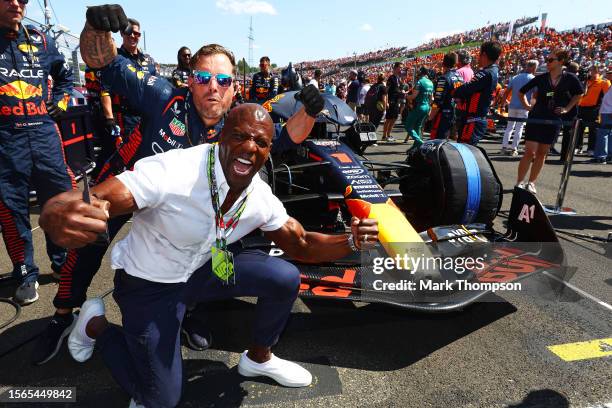 Terry Crews poses for a photo with the car of Max Verstappen of the Netherlands and Oracle Red Bull Racing on the grid during the F1 Grand Prix of...