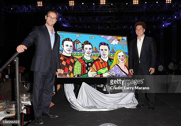 Jim Ferraro Jr. And artist Romero Britto pose onstage at the Zenith Watches Best Buddies Miami Gala at Marlins Park on November 16, 2012 in Miami,...