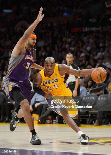 Kobe Bryant of the Los Angeles Lakers drives to the basket against the defense of Jared Dudley of the Phoenix Suns at Staples Center on November 16,...