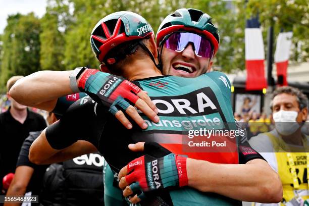 Nils Politt of Germany and stage winner Jordi Meeus of Belgium and Team BORA-Hansgrohe react after the stage twenty-one of the 110th Tour de France...