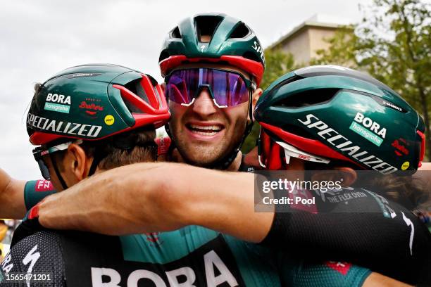 Danny Van Poppel of The Netherlands, stage winner Jordi Meeus of Belgium and Marco Haller of Austria and Team BORA-Hansgrohe react after the stage...
