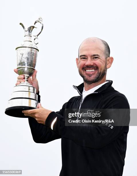 Brian Harman of the United States poses with the Claret Jug on the 18th Green following victory on Day Four of The 151st Open at Royal Liverpool Golf...