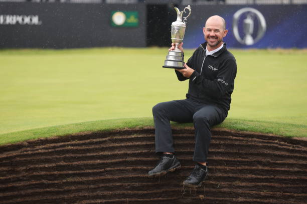Brian Harman of the United States poses for a photograph with the Claret Jug on the 18th green after winning The 151st Open on Day Four of The 151st...