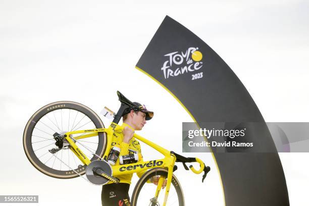 Jonas Vingegaard of Denmark and Team Jumbo-Visma - Yellow Leader Jersey celebrates at podium as final overall winner with a custom yellow Cervélo...