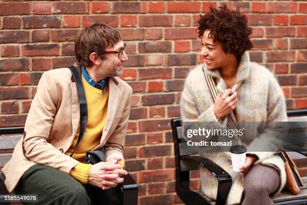 man and woman flirting on the street - stranger stock pictures, royalty-free photos & images