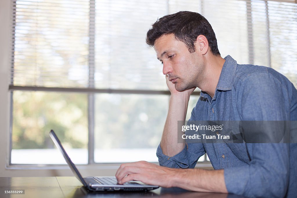 Man sitting in front of laptop computer