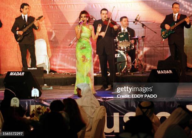 Lebanese pop singer Nawal al-Zoghbi sings in Dubai 01 March 2001, the first day of the Dubai Shopping Festival. Zoghbi is one of many Arab singers to...