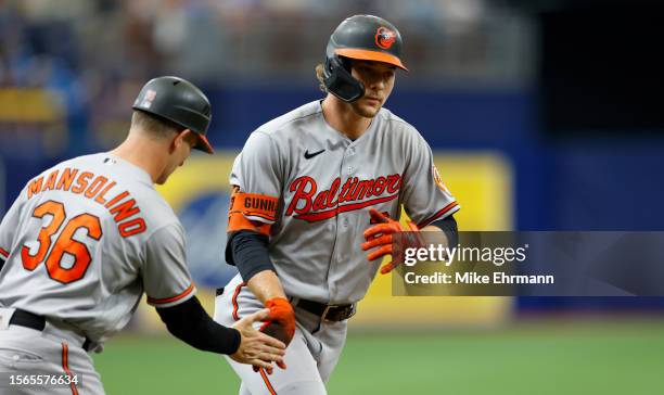 Gunnar Henderson of the Baltimore Orioles is congratulated after hitting a two run home run in the second inning during a game against the Tampa Bay...