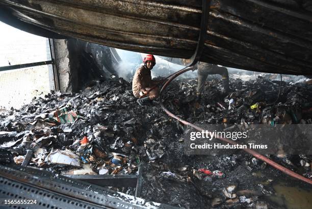 Firemen douse the fire that broke out at a footwear factory in west Delhi's Udyog Nagar near Peera Garhi Chowk in the morning, on July 30, 2023 in...