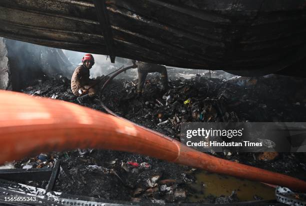 Firemen douse the fire that broke out at a footwear factory in west Delhi's Udyog Nagar near Peera Garhi Chowk in the morning, on July 30, 2023 in...