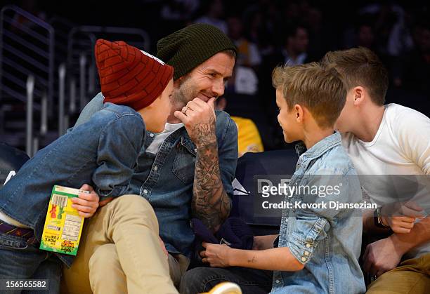 David Beckham and his sons Cruz Beckham Romeo Beckham and Brooklyn Beckham attend the Los Angeles Lakers and Phoenix Suns NBA basketball game at...