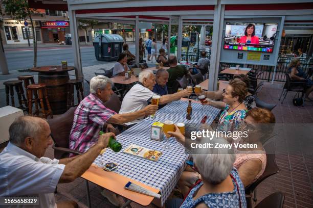 City center restaurant patrons dining as the first election polls are broadcast on television on July 23, 2023 in Benidorm, Spain. Voters in Spain...