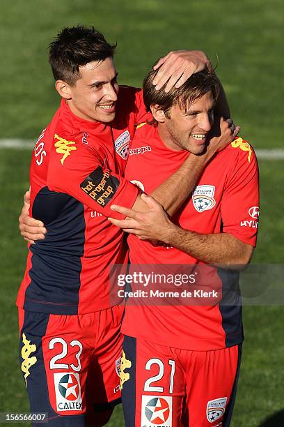 Evan Kostopoulos of Adelaide congratulates team mate Jeronimo Neumann after he scored a goal during the round seven A-League match between Adelaide...