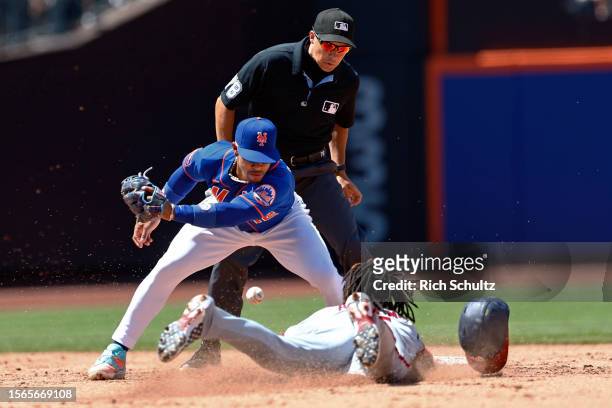 Abrams of the Washington Nationals steals second base as shortstop Francisco Lindor of the New York Mets can't handle the throw during the third...