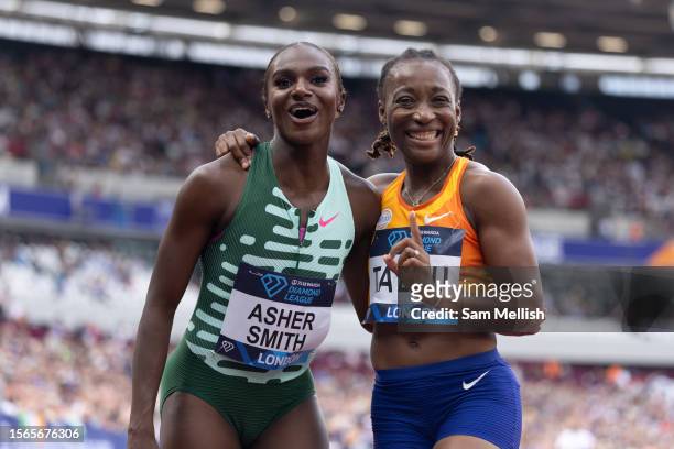 Dina Asher-Smith of Team Great Britain with Marie-Josee Ta Lou of Ivory Coast following the women's 100m during the London Athletics Meet, part of...