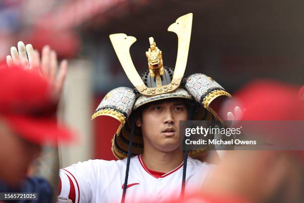 Shohei Ohtani of the Los Angeles Angels celebrates with teammates after hitting a solo home run against the Pittsburgh Pirates during the first...