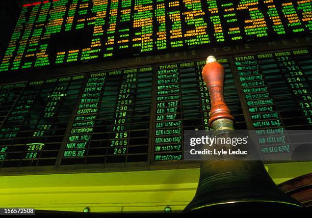 stock market display board with opening bell - campana de mano fotografías e imágenes de stock