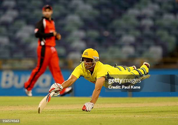 Nathan Coulter-Nile of the Warriors dives to make his crease during the Ryobi Cup One Day match between the Western Australia Warriors and the South...