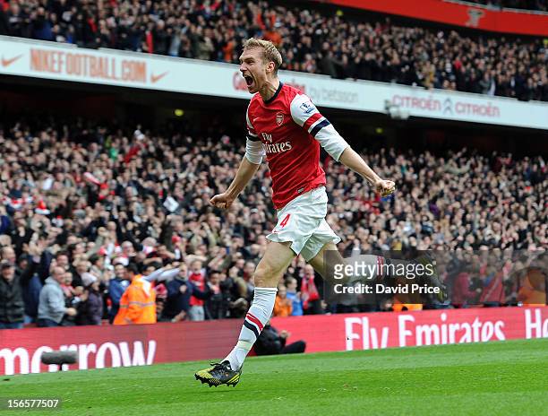 Per Mertesacker of Arsenal celebrates after scoring his team's first goal to equalise during the Barclays Premier League match between Arsenal and...