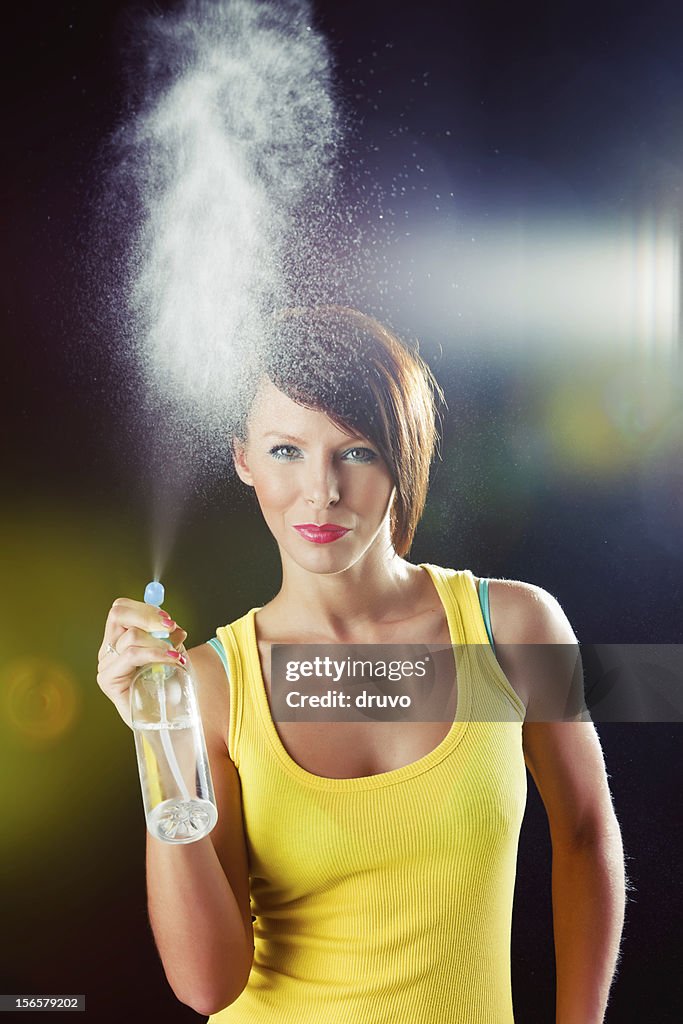 Young beautiful woman with spray bottle