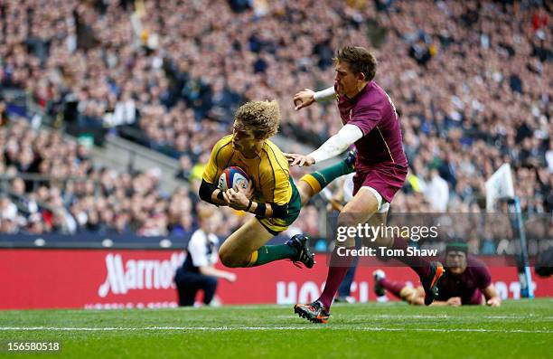 Nick Cummins of Australia scores a try past Toby Flood of England during the QBE International match between England and Australia at Twickenham...