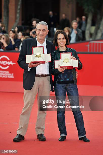 Producer Gianfilippo Pedote poses with the Tao Due Camera d'Oro 2012 Best Producer Award for the movie 'Tutti Parla di Te' and Claudia Pandolfi poses...