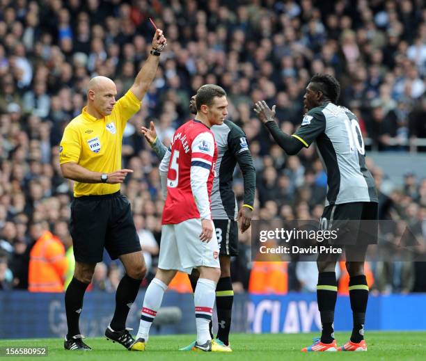 Referee Howard Webb shows the Red Card to Emmanuel Adebayor of Tottenham during the Barclays Premier League match between Arsenal and Tottenham...