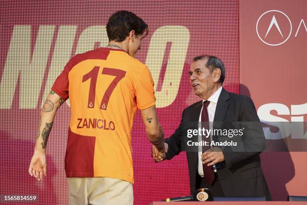 Galatasaray Club President Dursun Ozbek and Italian footballer Nicolo Zaniolo shake hands during the signing ceremony for the new transfers of...