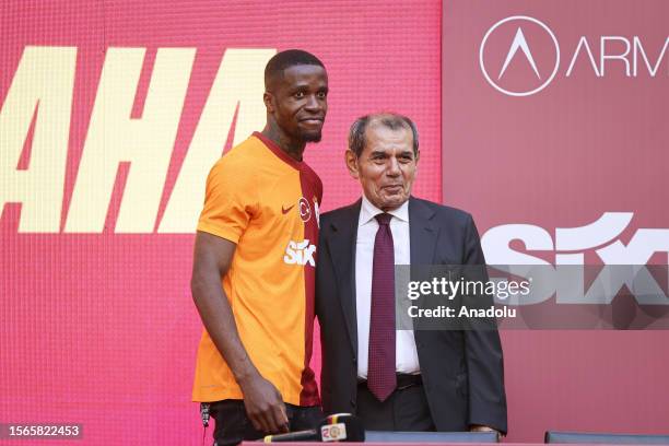 Galatasaray Club President Dursun Ozbek and Ivory Coast footballer Wilfried Zaha poses for a photo during the signing ceremony for the new transfers...