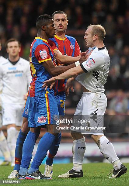 Wilfried Zaha and Joel Ward of Crystal Palace square up against Derby's Gareth Roberts during the npower Championship match between Crystal Palace...