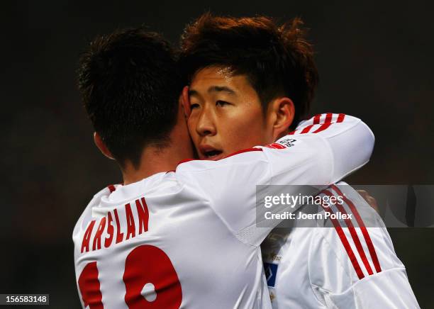 Heung Min Son of Hamburg celebrates with his team mate Tolgay Arslan after scoring his team's first goal during the Bundesliga match between...