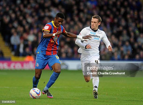 Wilfried Zaha of Crystal Palace looks to get past Derby's Craig Bryson during the npower Championship match between Crystal Palace and Derby County...