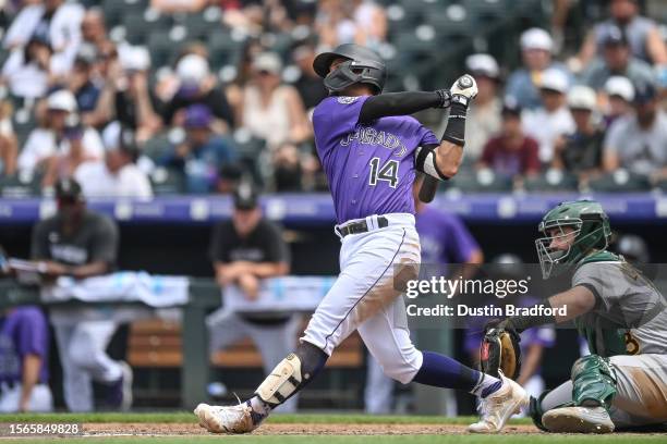 Ezequiel Tovar of the Colorado Rockies hits a double in fifth inning against the Oakland Athletics at Coors Field on July 30, 2023 in Denver,...