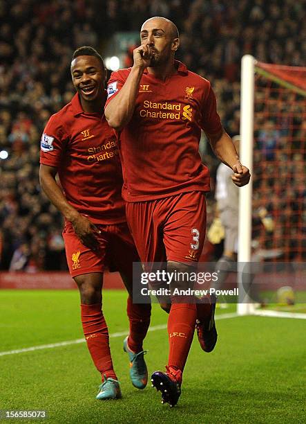 Jose Enrique of Liverpool celebrates his goal with Raheem Sterling during the Barclays Premier League match between Liverpool and Wigan Athletic at...