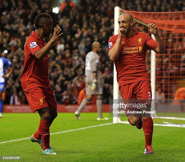 Jose Enrique of Liverpool celebrates his goal with Raheem Sterling during the Barclays Premier League match between Liverpool and Wigan Athletic at...
