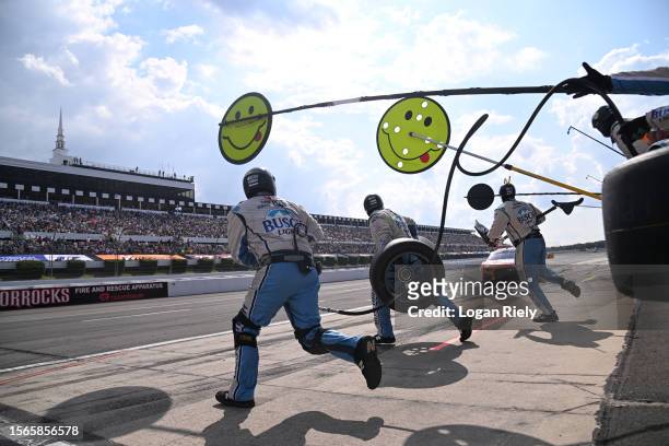 The pit crew of the Busch Light Peach Ford, driven by Kevin Harvick leap into action during the NASCAR Cup Series HighPoint.com 400 at Pocono Raceway...