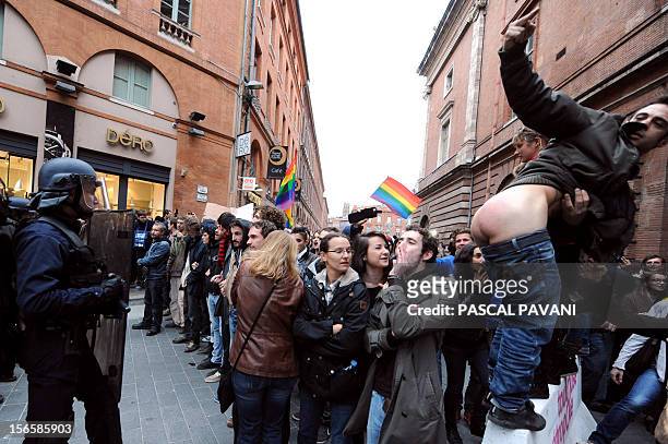 Man shows his buttocks to police as people take part in a demonstration in support with the same-sex marriage on November 17, 2012 in Toulouse,...