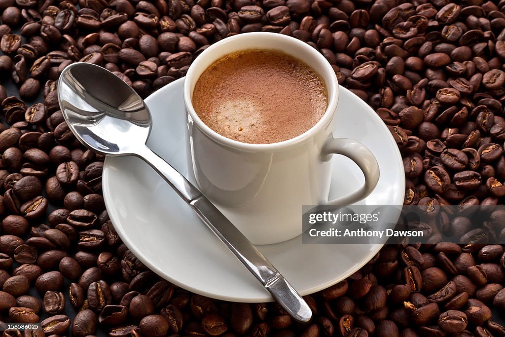 Espresso coffee on coffee beans