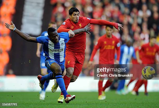 Luis Suarez of Liverpool in action with Maynor Figueroa of Wigan Athletic during the Barclays Premier League match between Liverpool and Wigan...