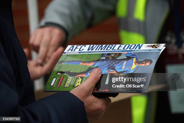 Man buys a match programme outside AFC Wimbledon's stadium before the npower League Two match between AFC Wimbledon and Aldershot Town at the Cherry...