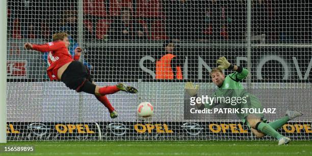 Leverkusen's striker Stefan Kiessling scores past Schalke's goalkeeper Lars Unnerstall during the German first division Bundesliga football match...