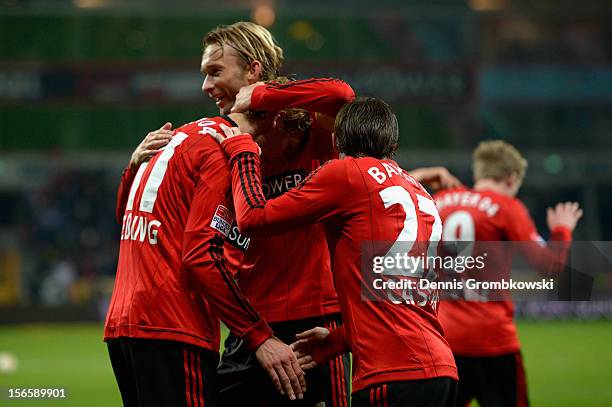 Stefan Kiessling of Leverkusen celebrates with his teammates Simon Rolfes and Gonzalo Castro after scoring his team's second goal during the...