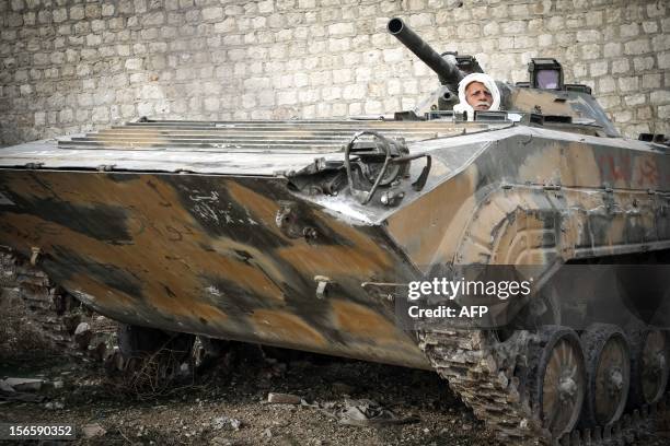 Abu Faez, 58-years-old, who served in the Syrian army as an officer between 1970 2002, mans a BMP personnel carrier in Free Syrian Army during...